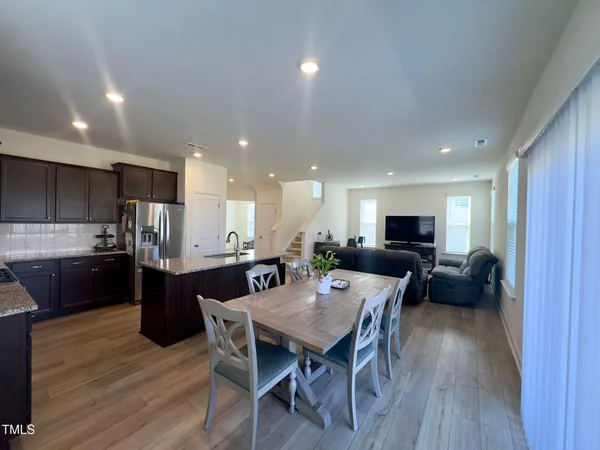 a kitchen with a table and chairs in it