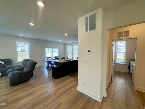 a living room with furniture and a wooden floor