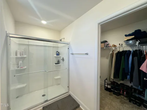 a bathroom with a shower and a mirror