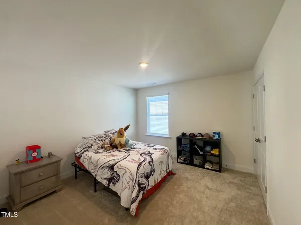 a bedroom with a bed and window