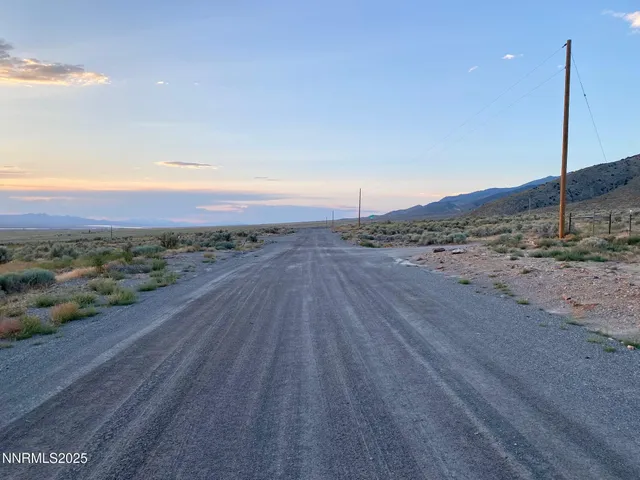an empty room with wooden floor and city view