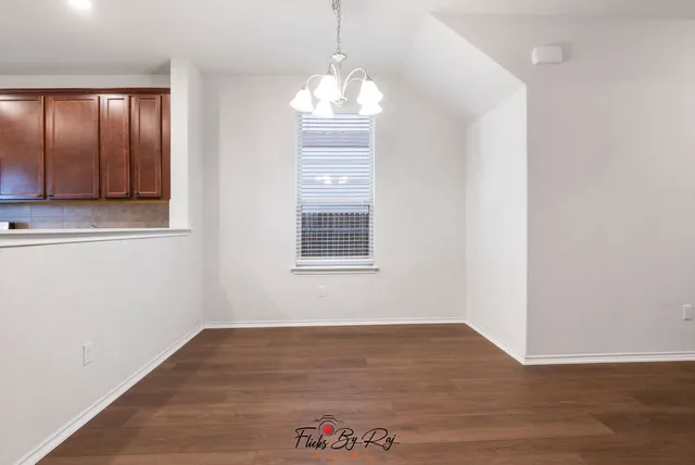 a view of entryway with kitchen and stairs