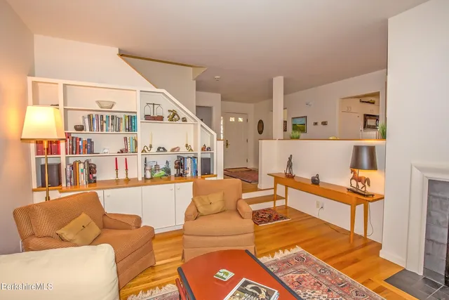 a living room with furniture and a book shelf