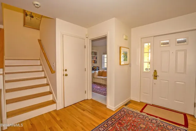 a view of a bedroom with wooden floor and entryway