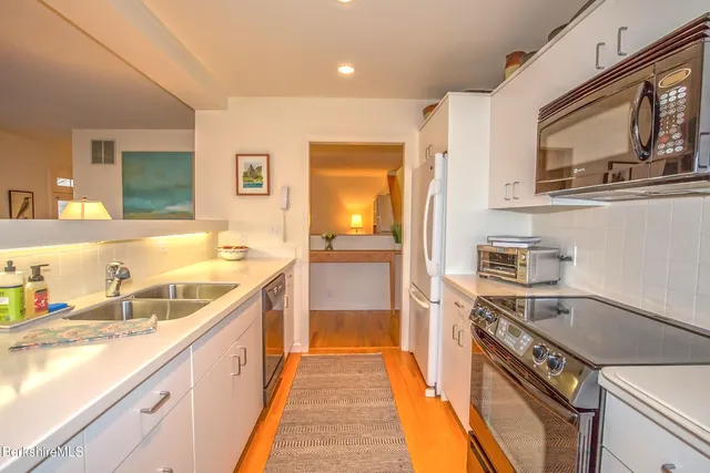 a kitchen with a sink and a stove top oven