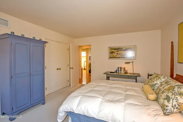 a bedroom with a bed and a lamp