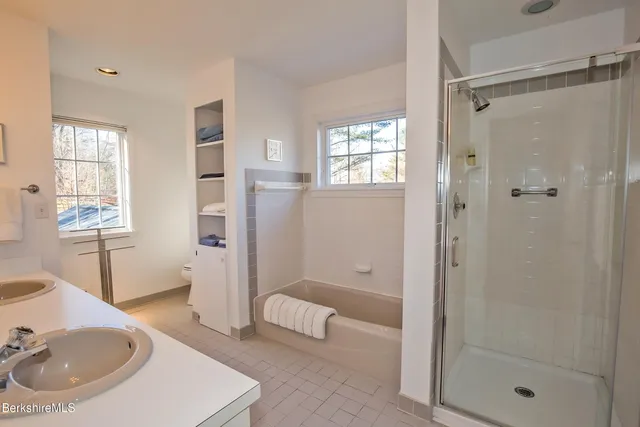 a bathroom with a sink toilet and shower