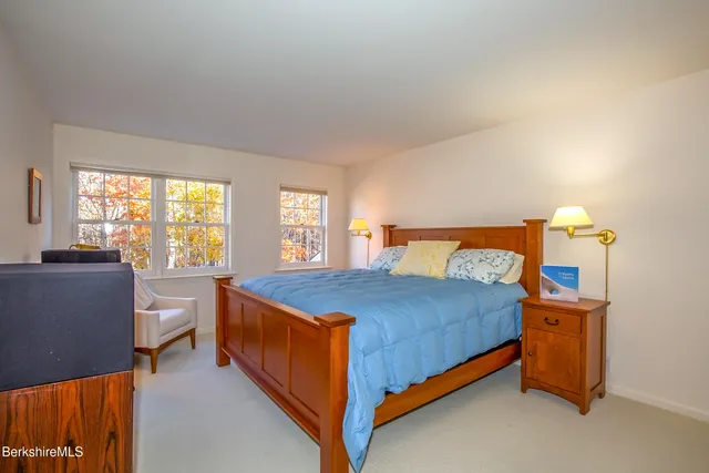 a bedroom with a bed and a lamp with window