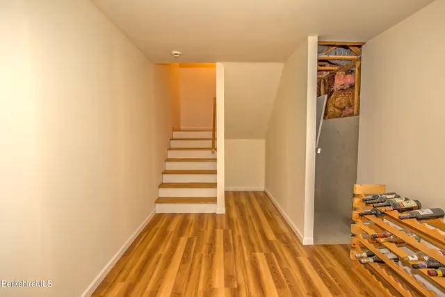 a view of a room with wooden floor and stairs