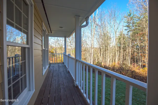 a view of a balcony with wooden floor