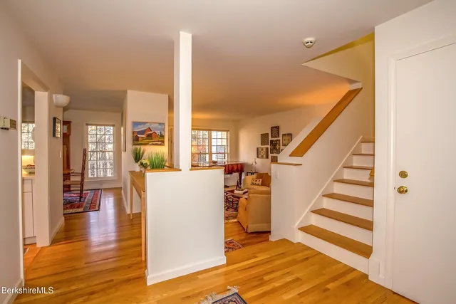 a view of a kitchen with furniture and wooden floor