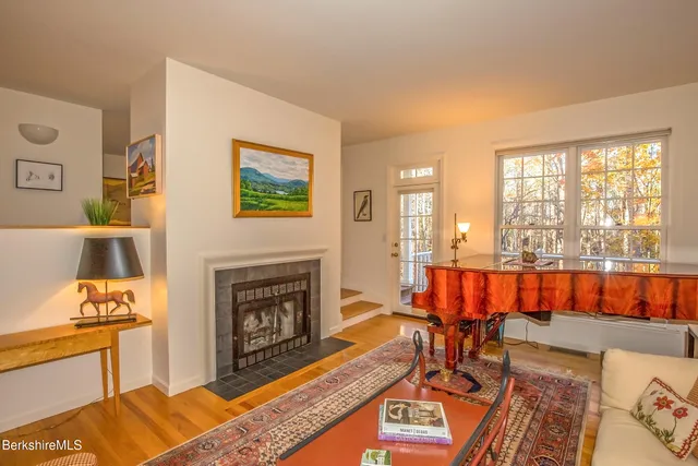 a living room with furniture a rug and a fireplace