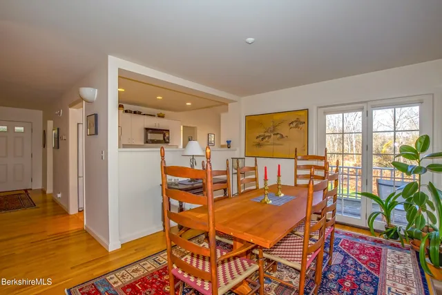 a living room with dining room and wooden floor