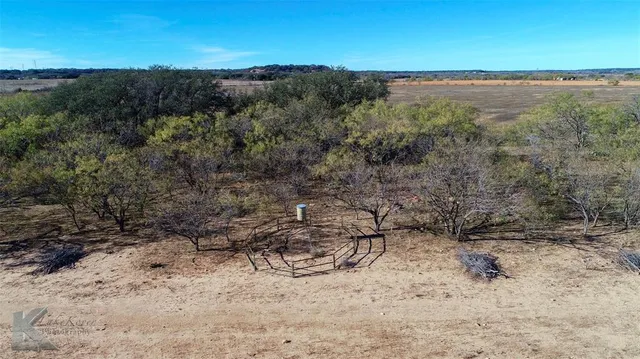 a view of a lake with beach and green space