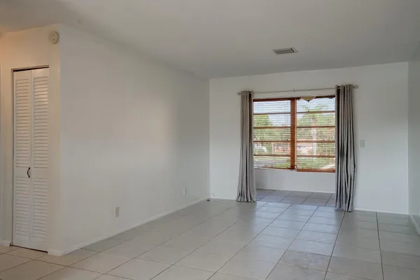 a view of an empty room with a window