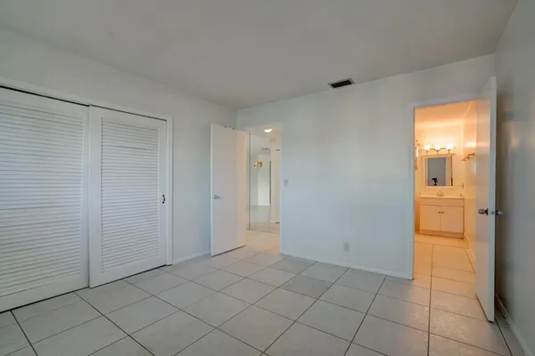 a view of an empty room and closet area