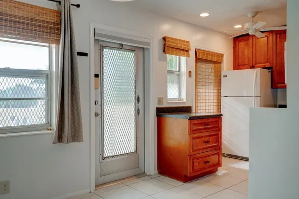 a room with furniture a large window and a refrigerator