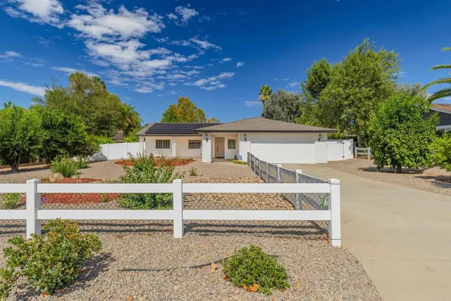 front view of a house with a bench