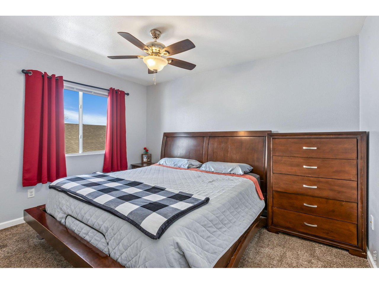 233 East 19th Street Road Greeley, CO 80631 - Photo 14 of 22 a bedroom with a bed and a chandelier