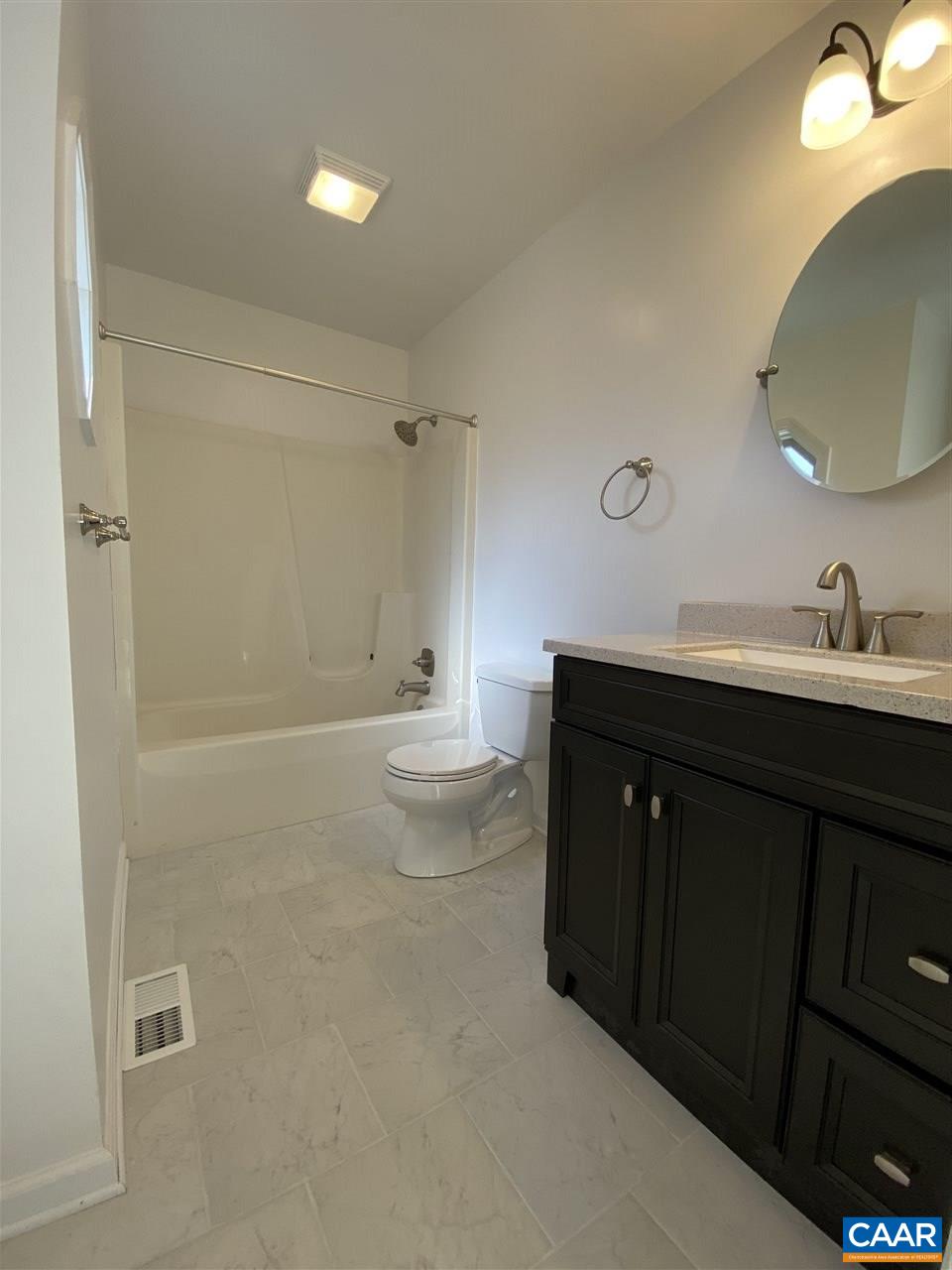 49 Laguna Road Palmyra, VA 22963 - Photo 19 of 27 a spacious bathroom with a double vanity sink toilet and a mirror