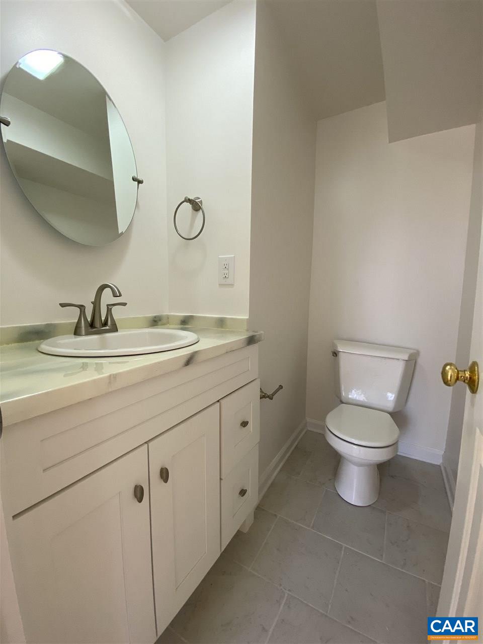 49 Laguna Road Palmyra, VA 22963 - Photo 24 of 27 a bathroom with a toilet a sink and mirror