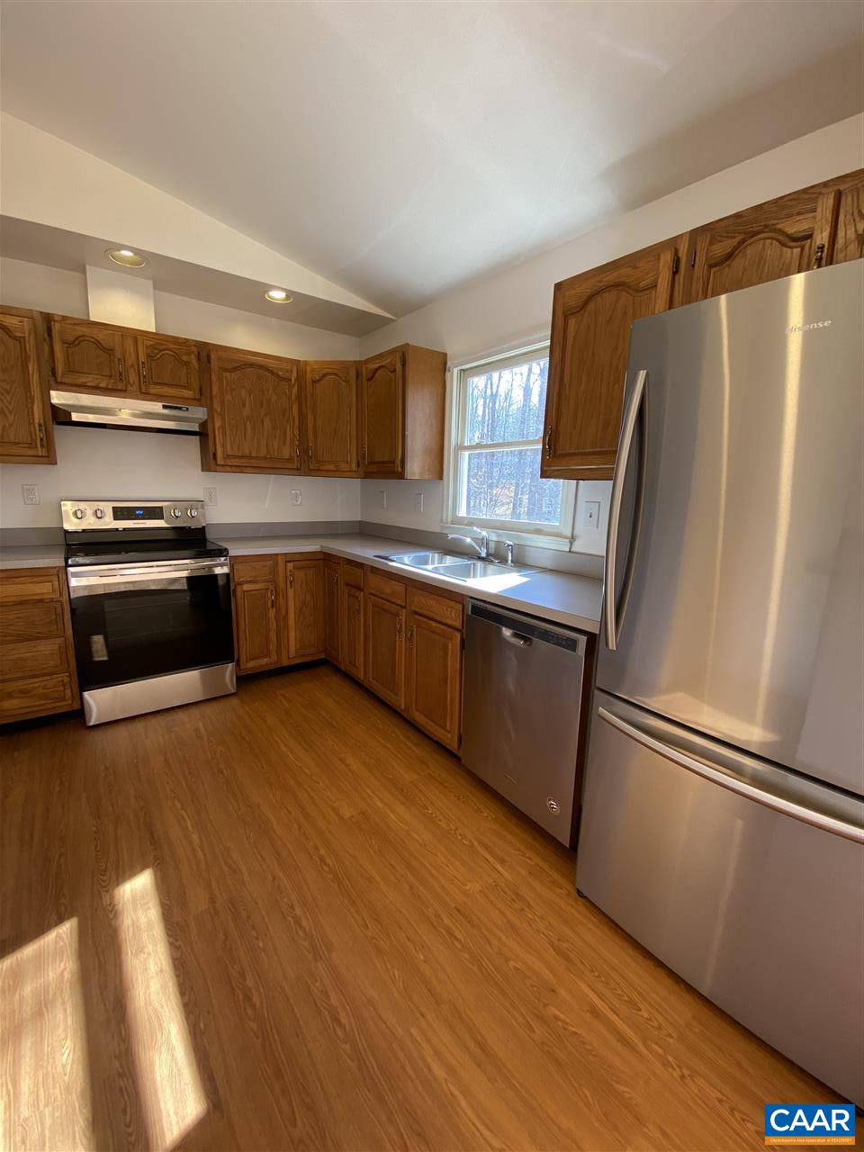 49 Laguna Road Palmyra, VA 22963 - Photo 9 of 27 a kitchen with stainless steel appliances granite countertop a refrigerator a sink dishwasher a stove and white countertops with wooden floor