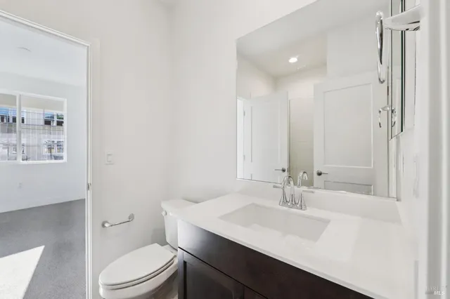 a bathroom with a sink a toilet a shower and a mirror