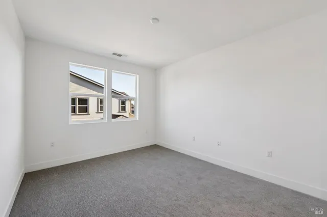 a view of an empty room with windows