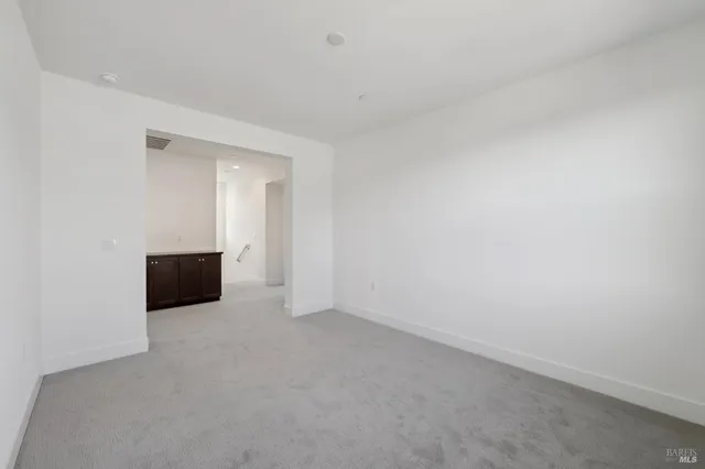 a view of an empty room and wooden floor