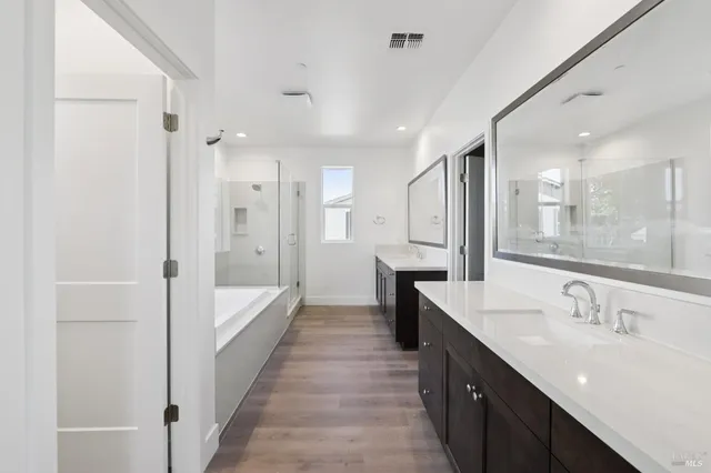 a bathroom with a double vanity sink mirror double and shower
