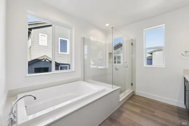 a spacious bathroom with a bathtub and a shower