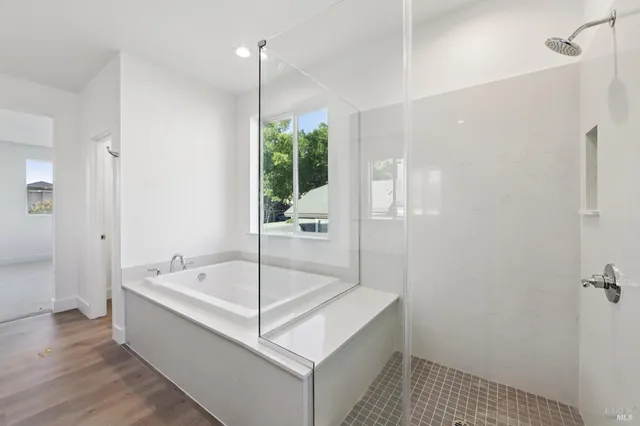 a bathroom with a tub a sink and a shower