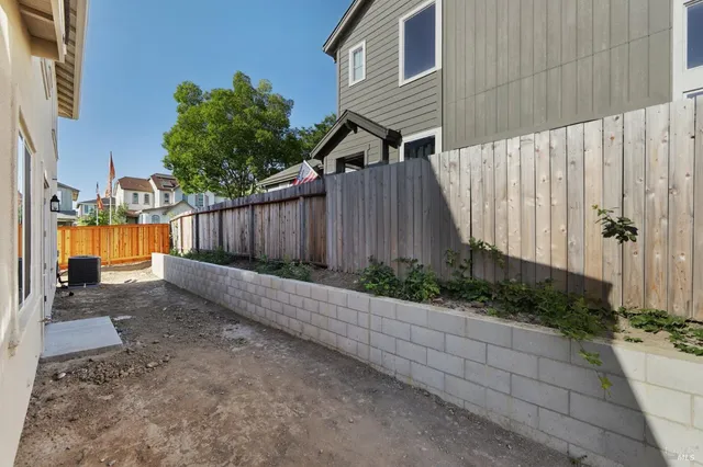 a view of a house with a wooden fence