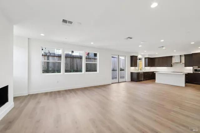 a view of kitchen with wooden floor and windows