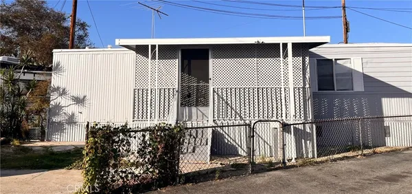 a view of a house with wooden fence
