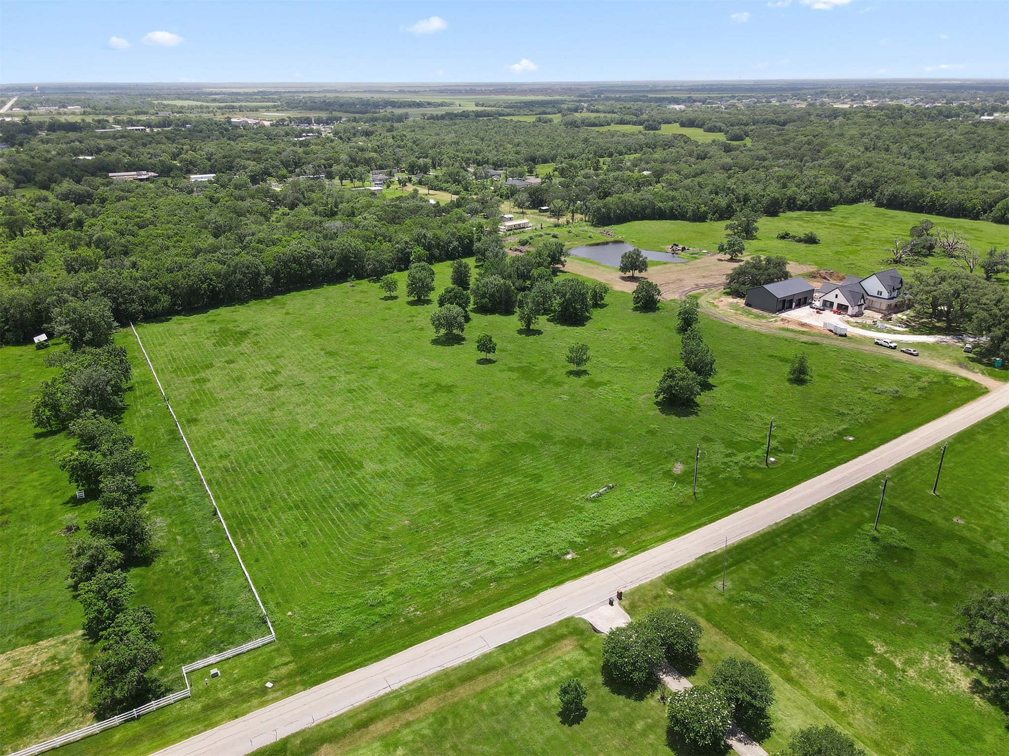 16403 Sun Valley Lane Rosharon, TX 77583 - Photo 8 of 15 a view of a lush green forest with a lake