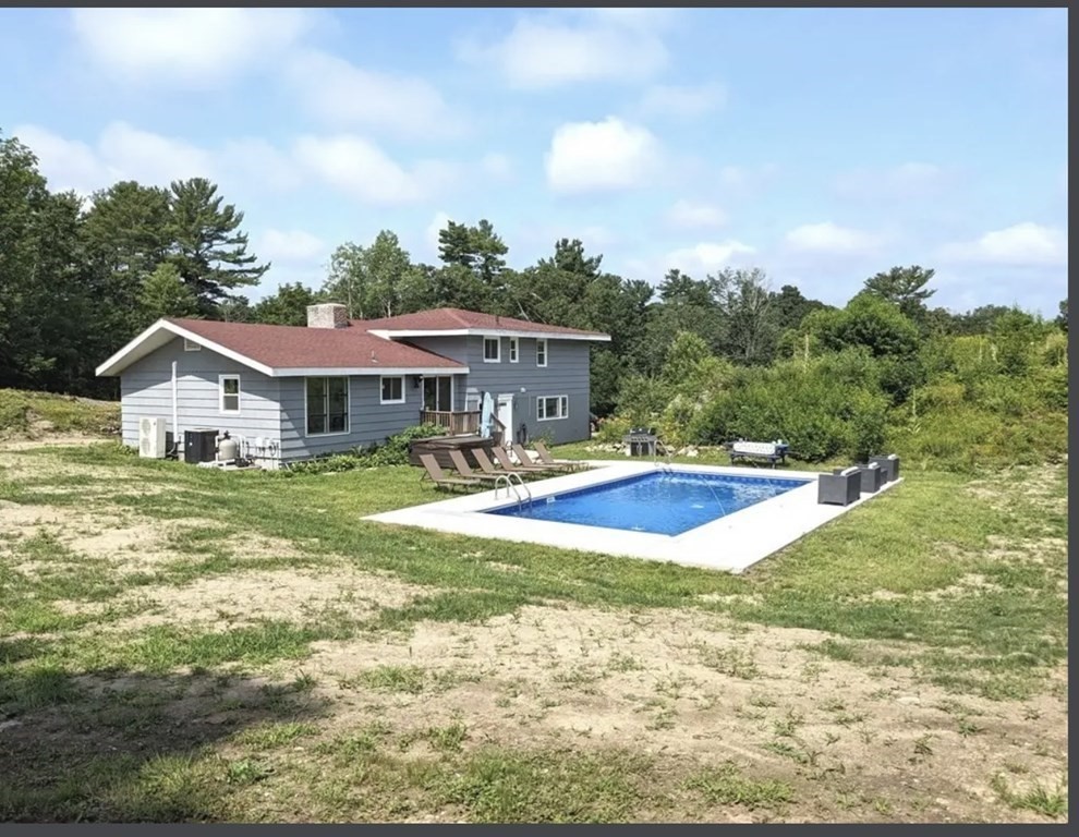 147 Forest Street Middleton, MA 01949 - Photo 1 of 32 a view of a house with swimming pool and yard