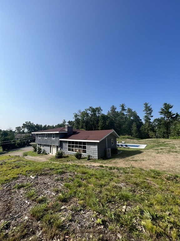 147 Forest Street Middleton, MA 01949 - Photo 22 of 32 a swimming pool with lots of trees in the background