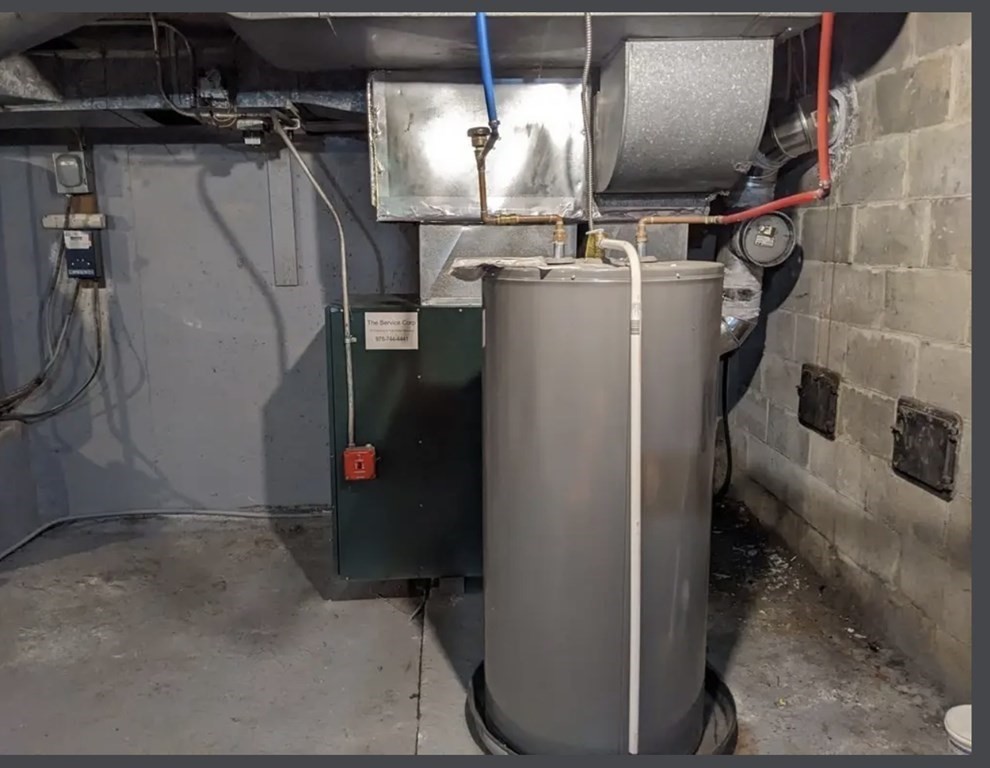 147 Forest Street Middleton, MA 01949 - Photo 31 of 32 a room with water heater and a refrigerator