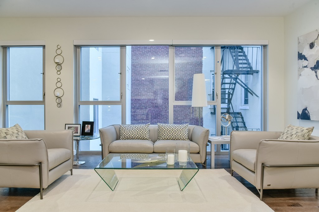 126 Salem Street, Unit 3 Boston, MA 02113 - Photo 3 of 14 a living room with furniture and a large window