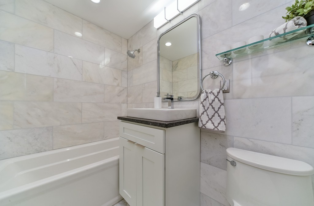 126 Salem Street, Unit 3 Boston, MA 02113 - Photo 7 of 14 a bathroom with a granite countertop sink a toilet and shower