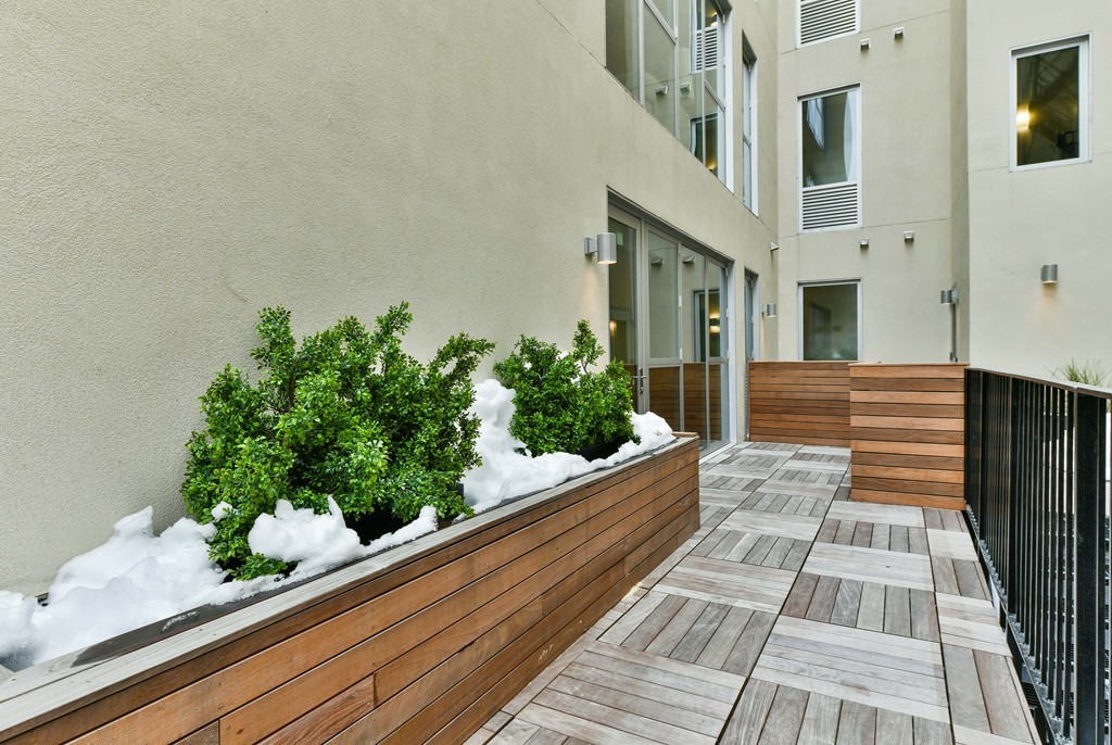 126 Salem Street, Unit 3 Boston, MA 02113 - Photo 10 of 14 a view of a balcony with wooden floor and potted plants