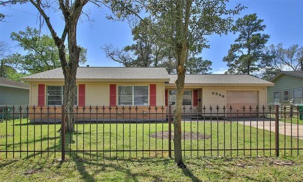 front view of a house with a iron fence