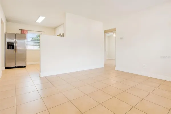 a view of a refrigerator in kitchen and a counter top space