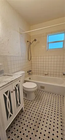 a bathroom with a sink a toilet a mirror and shower