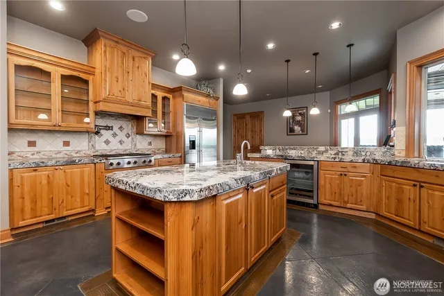a kitchen with stainless steel appliances granite countertop a stove microwave and sink