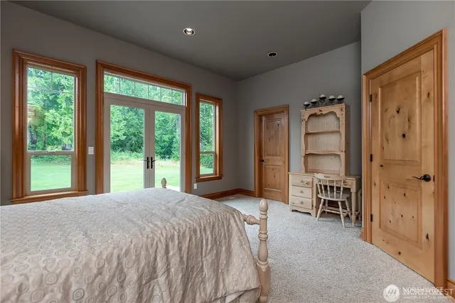 a bedroom with a large bed and a chandelier