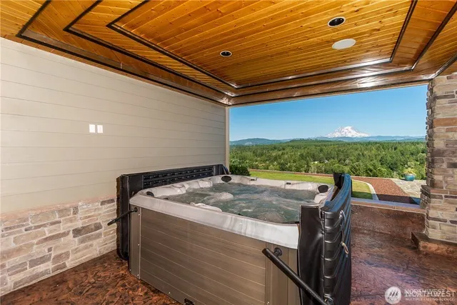an outdoor living area with a table and chairs