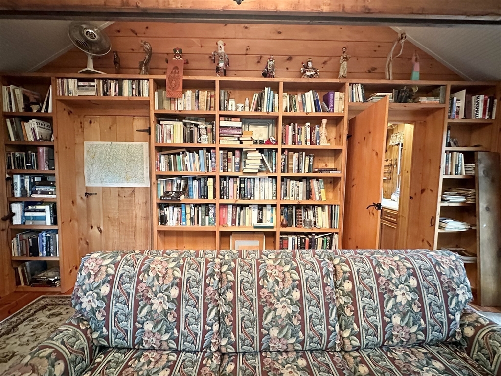 7 Burt Road Westhampton, MA 01027 - Photo 9 of 31 a bed sitting in a bedroom next to a book shelf