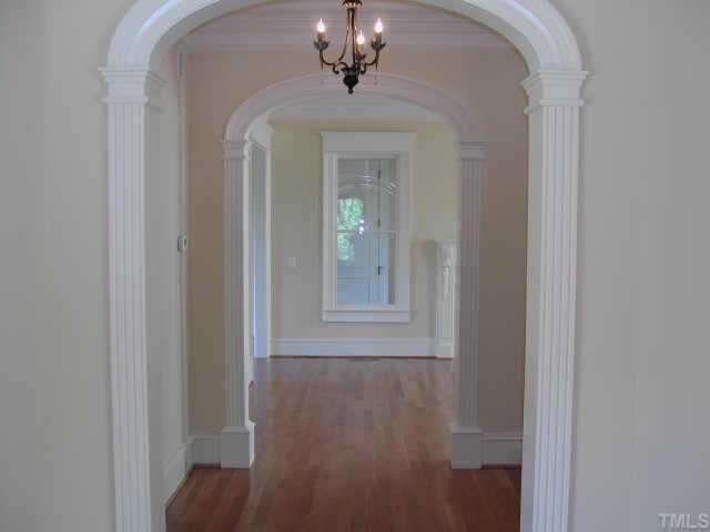7830 Monument Lane Raleigh, NC 27615 - Photo 4 of 10 Curved Millwork Openings welcome you to the first floor living areas